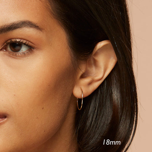 Classic hoop earrings in 14k gold and measuring 18mm.