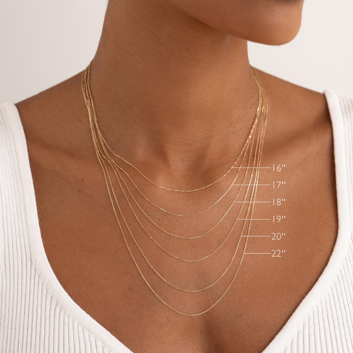 Model wearing layered 14k Gold Necklace Extender (2 inches) with gold chains in various lengths from 16 to 22 inches