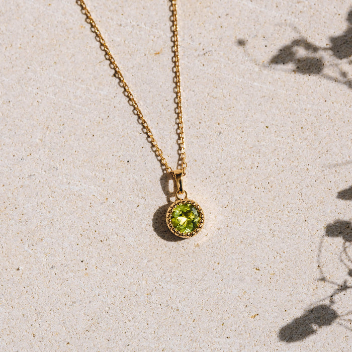Green pendant on gold chain necklace