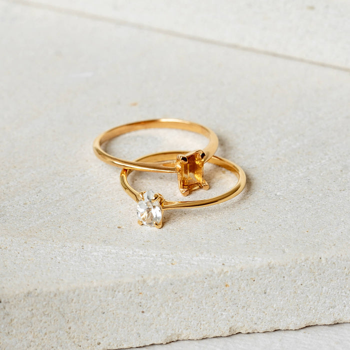 Two gemstone rings in gold with citrine and white topaz