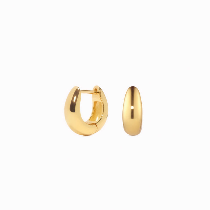 Close-up of Dome Huggie Earrings - Caja in polished gold vermeil with tapered dome shape on white background