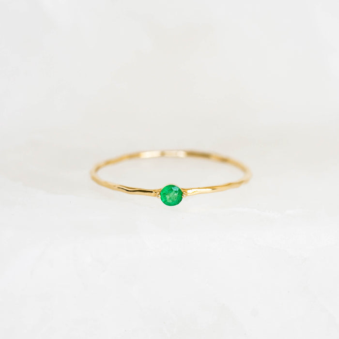 Emerald Ring 14k Gold - Penelope featuring a round lab grown emerald set on a delicate hammered gold band on white background