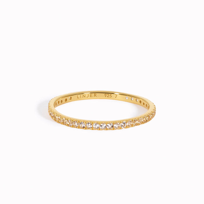White topaz eternity ring in gold vermeil on white background