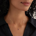 Close-up of a woman wearing the February Birthstone Pendant 14k Gold - Amethyst with a black collared shirt