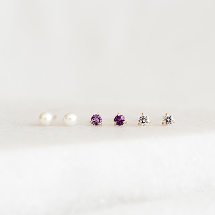 Three pairs of stud earrings including February Birthstone Stud Earrings 14k Gold - Amethyst with pearls and clear stones