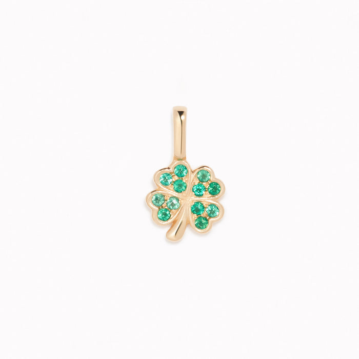 Four Leaf Clover Charm 14k Gold pendant with emerald gemstones displayed on a white background