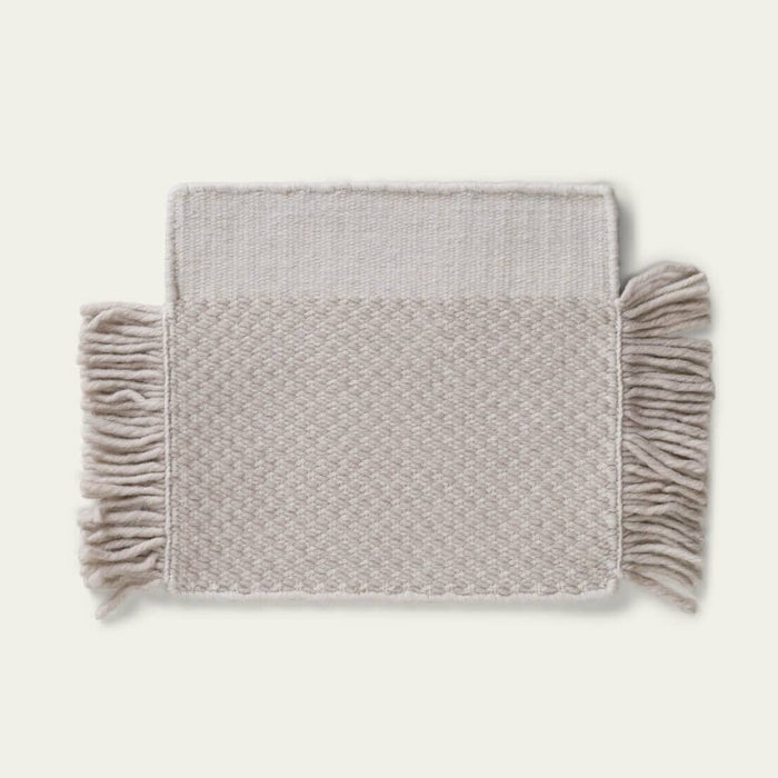 Fringe Wool Rug on a light beige background. #foggray