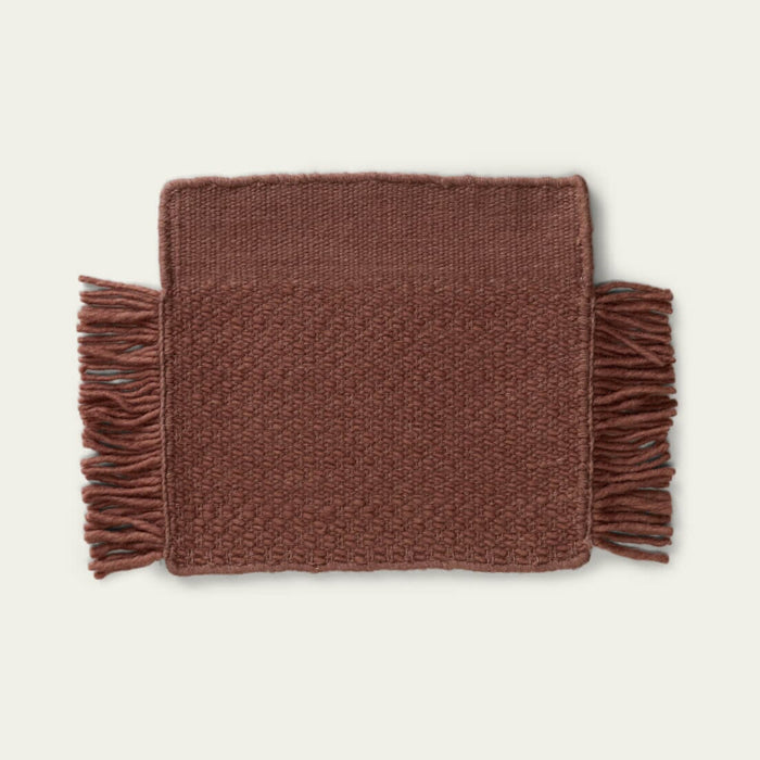 Fringe Wool Rug on a light beige background. #sunsettan