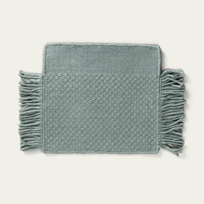 Fringe Wool Rug on a light beige background. #sagegreen