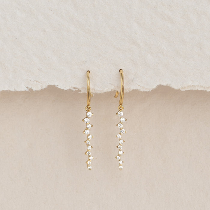 Gemstone Drop Earrings - Tamara featuring 22 cubic zirconia stones set in gold vermeil on a neutral textured background