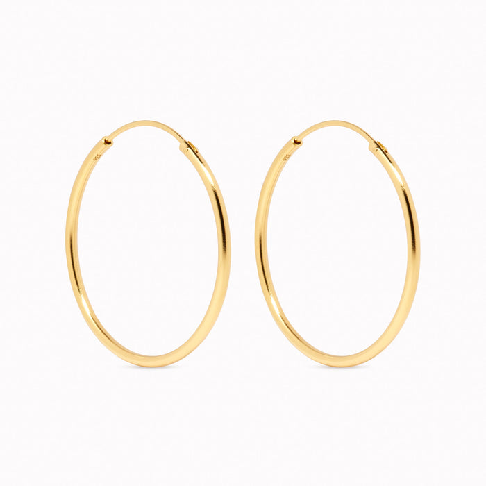 Large thin hoop earrings with hinged back in gold vermeil