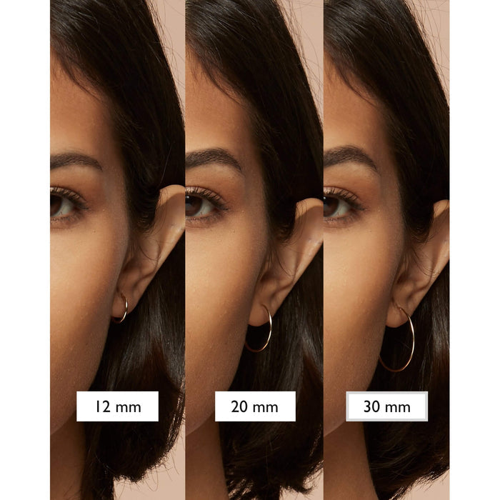 Gold hoop earrings in different sizes on model