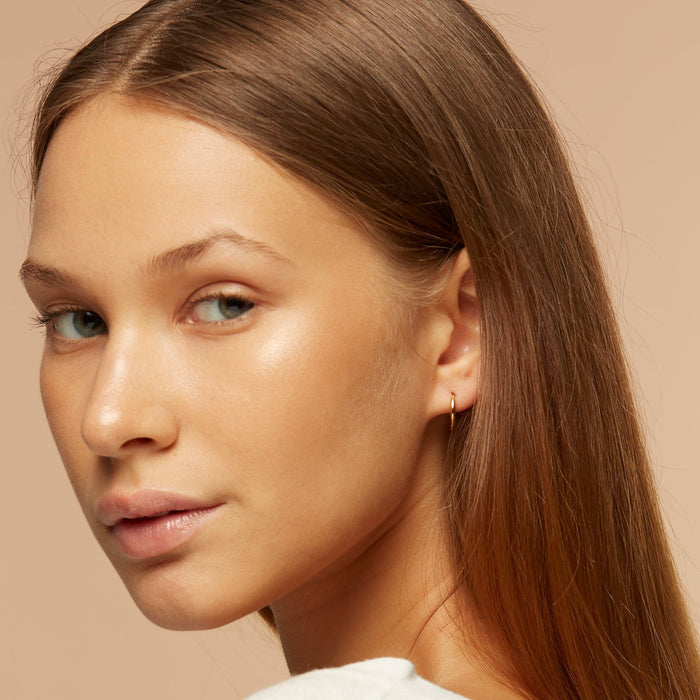 Gold vermeil huggie hoops on model