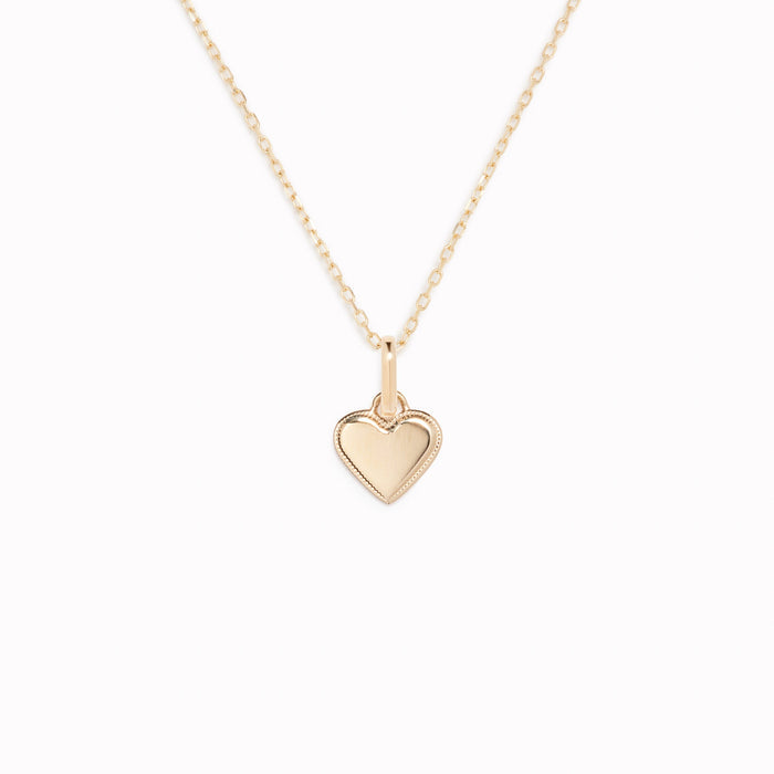 Heart Charm 14k Gold pendant with delicate beaded border on a fine chain displayed on a white background
