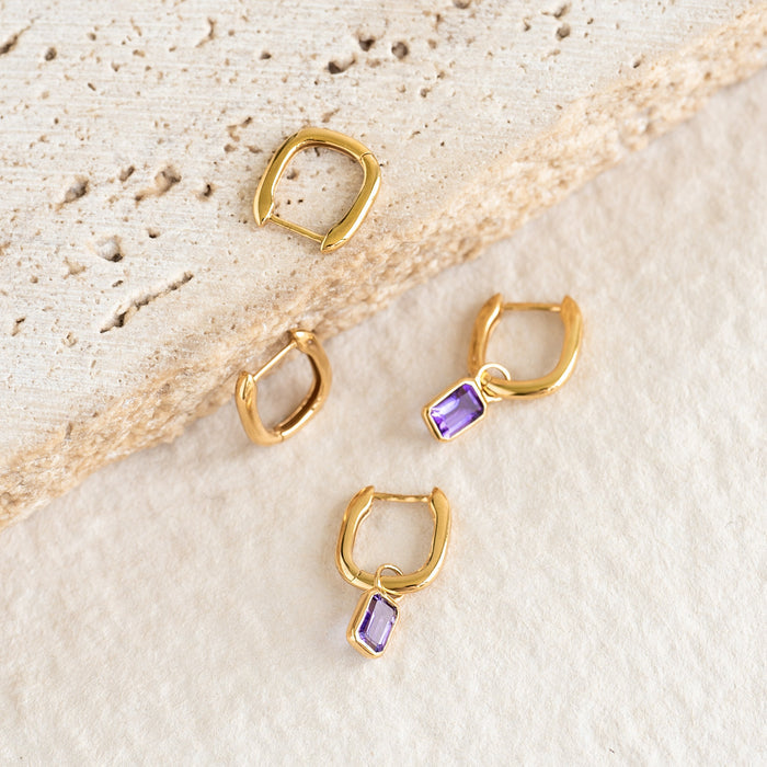 Huggie Earrings with Baguette Charms Amethyst - Amelia displayed with and without detachable purple baguette charms on textured surface