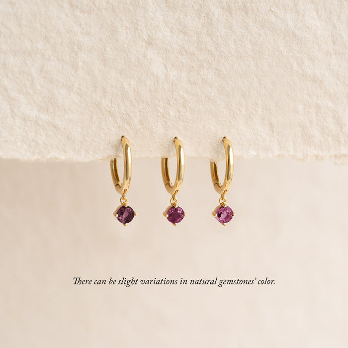 July Birthstone Drop Huggie Earrings - Pink Tourmaline with gold vermeil hoops and pink gemstone drops on a neutral background