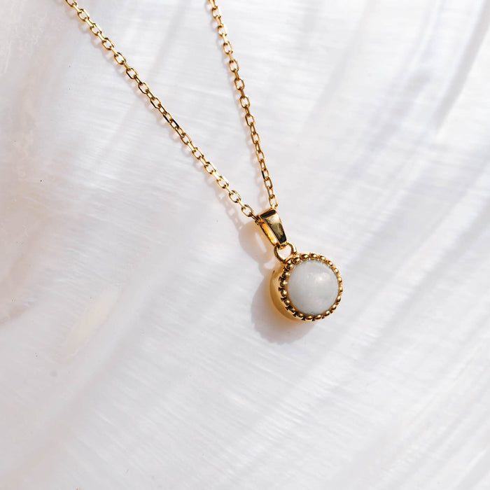 Mother of pearl pendant on gold chain necklace