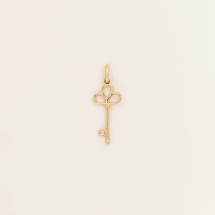 Yellow Gold key-shaped pendant design and polished finish, shown against a light neutral background.