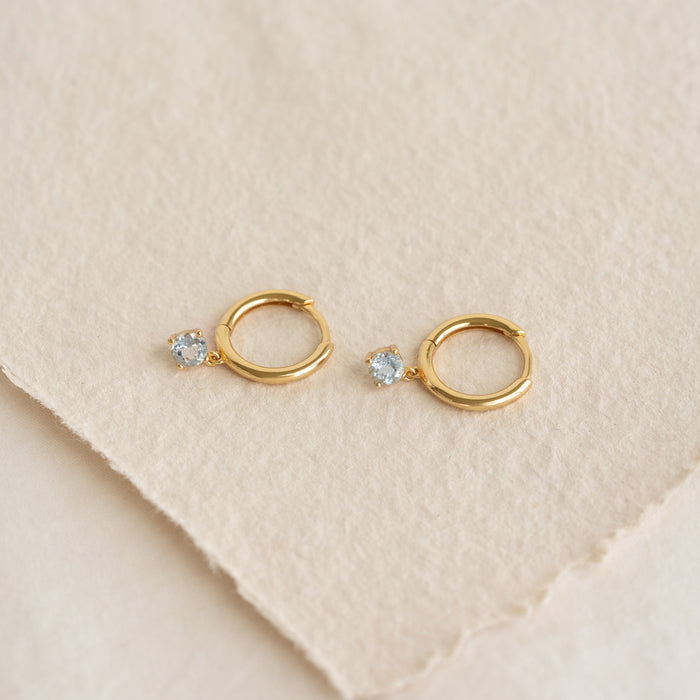 March Birthstone Drop Huggie Earrings - Aquamarine with pale blue gemstones set in gold vermeil on textured background