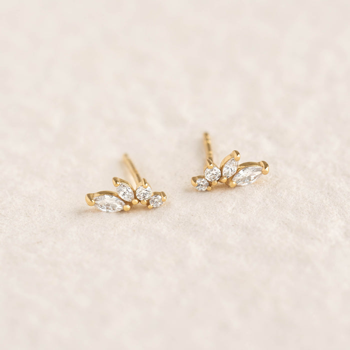 Close-up of Marquise Wing Earrings - Ava featuring gold vermeil and sparkling marquise cut gemstones on a soft beige background