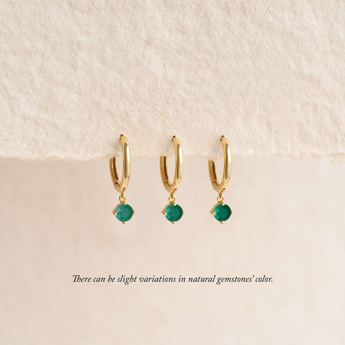 Close-up of May Birthstone Drop Huggie Earrings - Green Chalcedony on a beige background noting there can be slight variations in natural gemstones' color