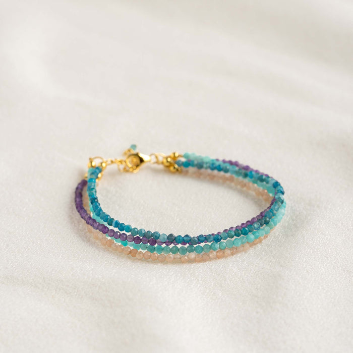 Multi Strand Beaded Bracelet featuring four strands of delicate amethyst, amazonite, sunstone, and apatite beads on a neutral background