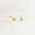 November Birthstone Stud Earrings 14k Gold - Citrine with small round citrine gemstones set in three-prong settings on a white surface