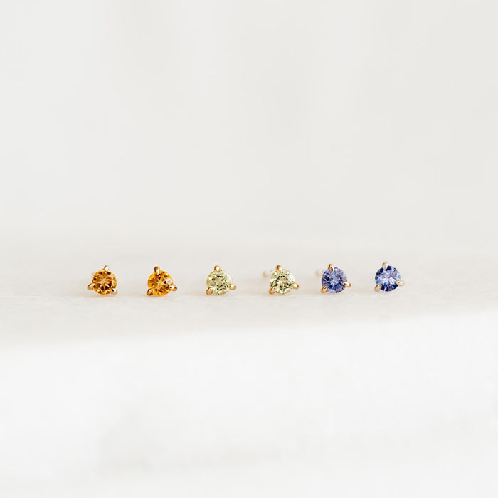 November Birthstone Stud Earrings 14k Gold - Citrine, peridot, and tanzanite gemstones in three-prong settings on white background