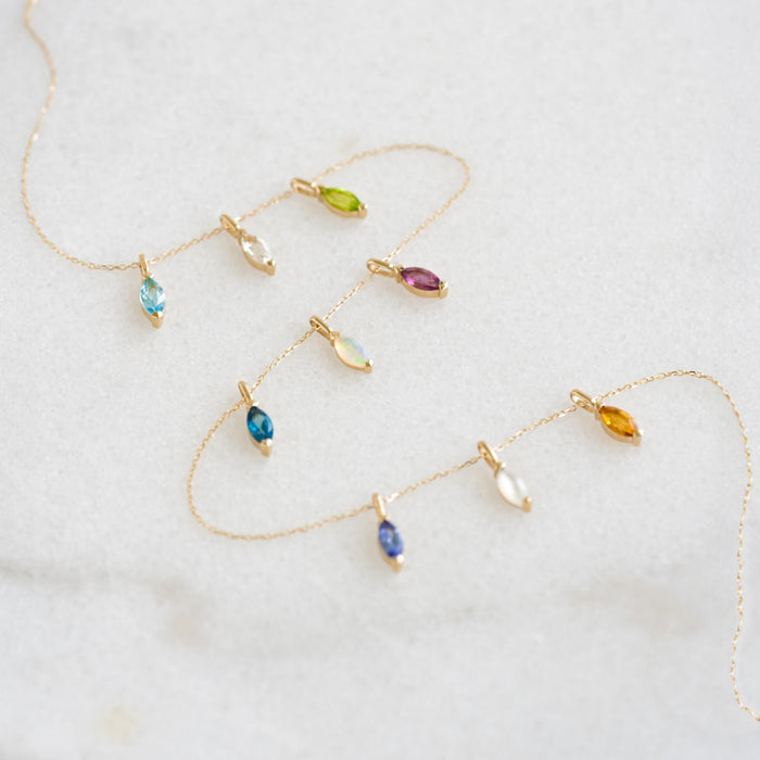 October Birthstone Pendant 14k Gold - Opal and other marquise-cut gemstone charms on delicate gold chains on white background