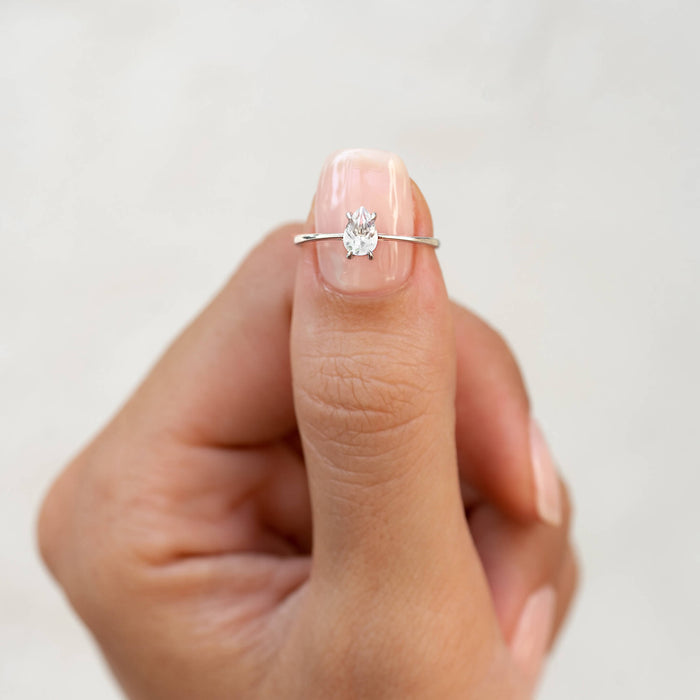 Pear Shaped Ring Silver - Martine with a 6x4mm white topaz solitaire on a slender silver band worn on thumb