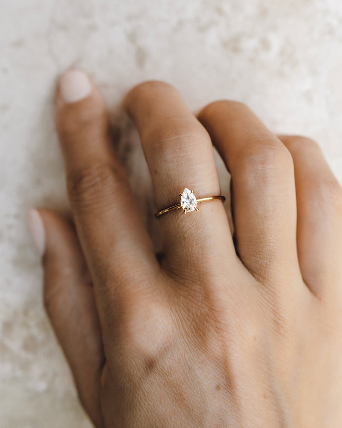 Solitaire pear shaped ring with white topaz on gold vermeil band
