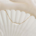 Close-up of Pearl Boat Necklace - Zanna featuring five graduated freshwater pearls on a gold vermeil beaded chain
