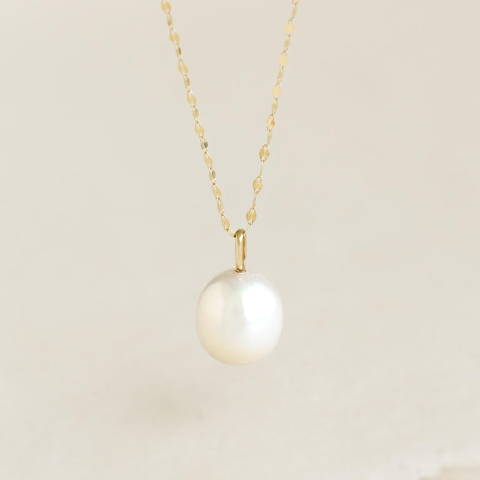 Pearl Charm 14k Gold featuring a single rice pearl pendant on a delicate 14k yellow gold chain against a neutral background