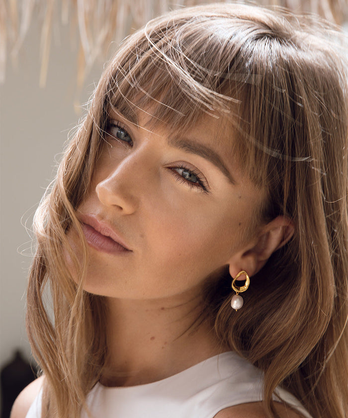 Baroque pearl earrings with gold vermeil on model