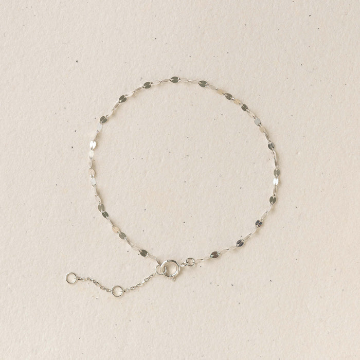 Petal Chain Bracelet White Gold - Florence with delicate petal-shaped links on a neutral beige background