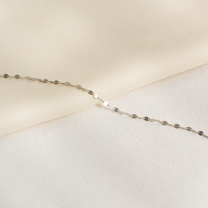 Close-up of Petal Chain Bracelet White Gold - Florence with delicate petal-shaped links on a soft neutral background