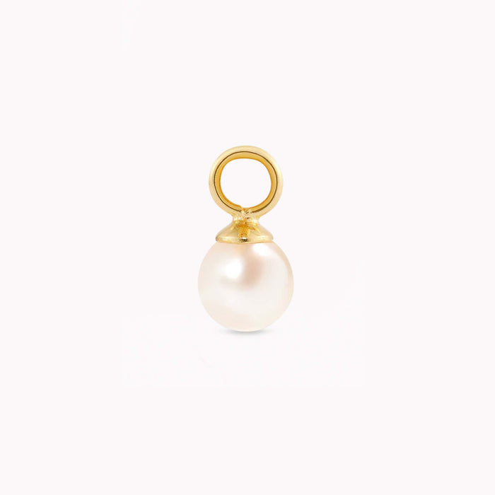 Gold and pearl pendant against a plain white background. The smooth, round pearl hangs from a small, shiny gold loop, conveying elegance and simplicity.