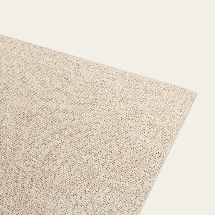 A beige, low profile rug pad made from natural rubber and handwoven jute fibers, designed to fit beneath a rug. #natural