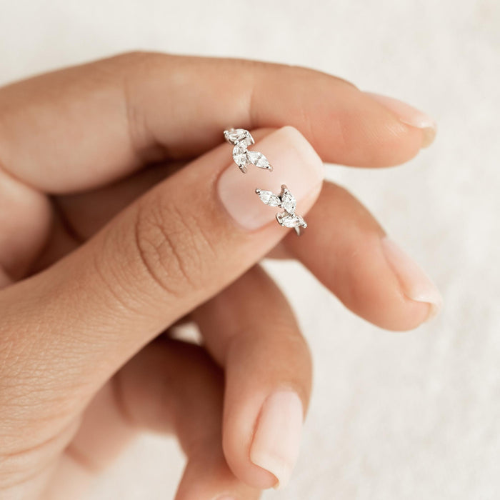 Laurel-inspired pattern of marquise gemstones on an open silver ring