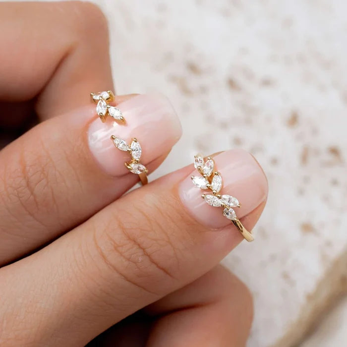 Gold ring featuring cubic zirconia adorned in leaf shapes
