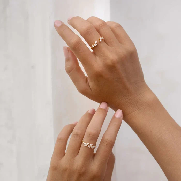 Open gold ring with a laurel-inspired pattern and brilliant marquise gemstones
