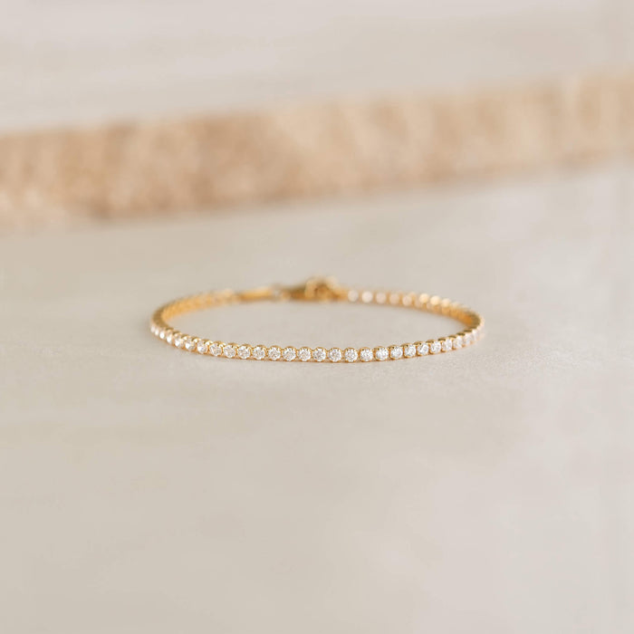 Close-up of the Tennis Bracelet - Audrey featuring sparkling cubic zirconia stones set in gold vermeil on a neutral surface