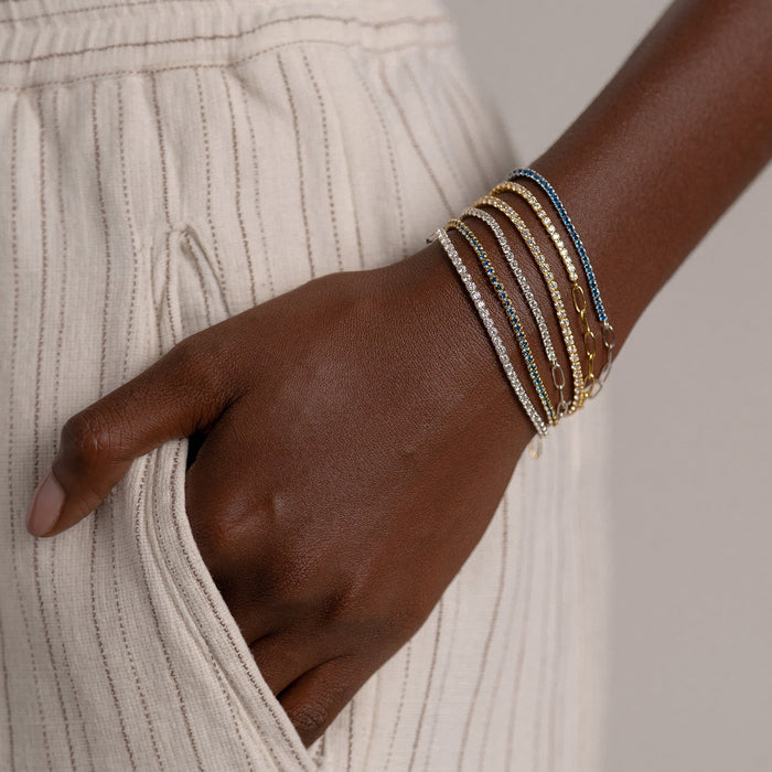 Silver and gold vermeil tennis bracelets with white gemstones and blue gemstones