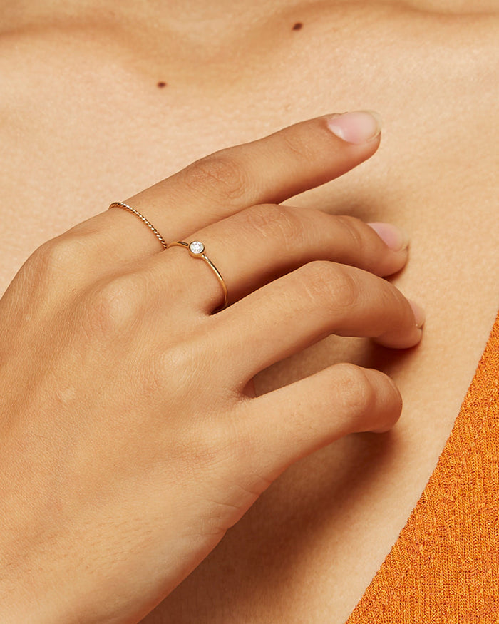 Solid gold stacking rings on model with twist ring