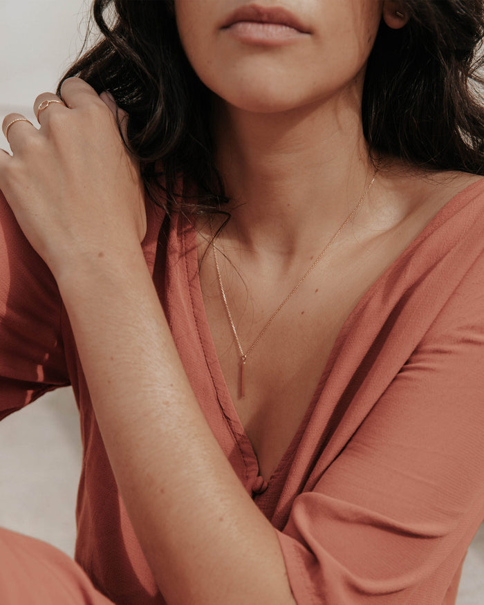Gold pendant necklace on model