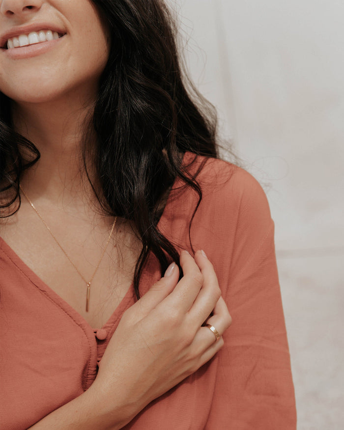 Gold vermeil bar pendant on model
