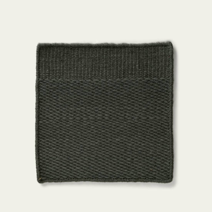 Green textured rug on a light gray background, #forestgreen